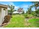Lush green backyard featuring mature trees and landscaping, offering privacy at 2900 Hammock Dr, Plant City, FL 33566