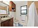 Classic bathroom featuring granite countertop, wood cabinets, and a combined shower and bathtub at 2900 Hammock Dr, Plant City, FL 33566