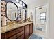 Stylish bathroom with granite countertop, dual mirrors, modern fixtures, and convenient access to the toilet at 2900 Hammock Dr, Plant City, FL 33566