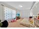 Bright bedroom with rainbow decor, featuring a TV set and a large closet for ample storage at 2900 Hammock Dr, Plant City, FL 33566