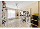 Bright bedroom featuring a vanity, open storage for shoes, and natural light from the window at 2900 Hammock Dr, Plant City, FL 33566