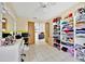 Bedroom featuring open closet, vanity with light, and a stylish transition into the living room at 2900 Hammock Dr, Plant City, FL 33566