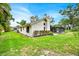 Exterior side view of home showing screened in porch, chimney and beautiful landscaping at 2900 Hammock Dr, Plant City, FL 33566
