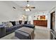 Cozy living room with vaulted ceilings, stylish sectional sofa, and seamless flow to the adjacent kitchen area at 2900 Hammock Dr, Plant City, FL 33566