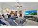 Inviting living room featuring a plush sectional sofa, open layout, and a view into the modern kitchen at 2900 Hammock Dr, Plant City, FL 33566