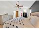 Bright bedroom featuring a ceiling fan and a glimpse into the en-suite bathroom at 2900 Hammock Dr, Plant City, FL 33566