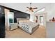 Spacious primary bedroom with a modern accent wall and natural light coming through the big windows at 2900 Hammock Dr, Plant City, FL 33566