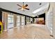 Bright sunroom with tile flooring, dark accent wall and sliding doors with access to the outdoors at 2900 Hammock Dr, Plant City, FL 33566