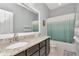 Bright bathroom with granite countertop vanity, neutral paint and large mirror at 8410 Red Spruce Ave, Riverview, FL 33578