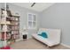 Bedroom featuring built-in shelving, futon sofa, and window, perfect for a guest room or home office at 8410 Red Spruce Ave, Riverview, FL 33578
