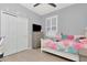 Bright bedroom featuring a window, light wood floor, closet, and playful decor at 8410 Red Spruce Ave, Riverview, FL 33578