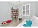 Bedroom featuring built-in shelving, futon sofa, and window, perfect for a guest room or home office at 8410 Red Spruce Ave, Riverview, FL 33578
