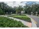 Landscaped community entrance featuring a gated entrance, brick pillars, and lush greenery for a grand sense of arrival at 8410 Red Spruce Ave, Riverview, FL 33578