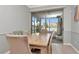 Dining room features a wood table and sliding glass door leading to the screened patio at 8410 Red Spruce Ave, Riverview, FL 33578