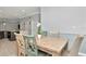 Dining room features a wood table and open layout to kitchen and multiple entryways at 8410 Red Spruce Ave, Riverview, FL 33578