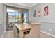 Dining room features a wood table and sliding glass door leading to the screened patio at 8410 Red Spruce Ave, Riverview, FL 33578