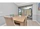 Dining room features a wood table and sliding glass door leading to the screened patio at 8410 Red Spruce Ave, Riverview, FL 33578