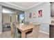 Dining room features a wood table and a sliding glass door leading to the screened patio at 8410 Red Spruce Ave, Riverview, FL 33578