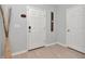 Clean entryway featuring a white door, modern decor, and light-colored wood floors for a welcoming ambiance at 8410 Red Spruce Ave, Riverview, FL 33578