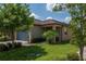 Charming home featuring a two-car garage and well-manicured lawn with mature trees and tasteful landscaping at 8410 Red Spruce Ave, Riverview, FL 33578