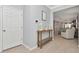 Bright foyer with light wood flooring, a decorative table, and views into the open-concept living space at 8410 Red Spruce Ave, Riverview, FL 33578
