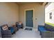 Charming covered front porch with comfortable seating and stylish decor, perfect for enjoying the outdoors at 8410 Red Spruce Ave, Riverview, FL 33578