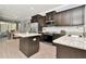 Well-lit kitchen boasts dark cabinetry, stainless appliances, and a dining area in view at 8410 Red Spruce Ave, Riverview, FL 33578