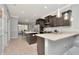 Modern kitchen with stainless steel appliances, granite countertops, and adjacent dining area at 8410 Red Spruce Ave, Riverview, FL 33578