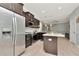 Spacious kitchen featuring dark wood cabinets, stainless appliances, and a central island at 8410 Red Spruce Ave, Riverview, FL 33578
