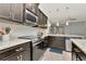 Modern kitchen features stainless steel appliances, dark cabinetry and granite countertops at 8410 Red Spruce Ave, Riverview, FL 33578
