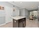 Kitchen island features granite countertop, stainless steel hardware, and light gray colored walls at 8410 Red Spruce Ave, Riverview, FL 33578