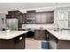 Stylish kitchen features stainless steel appliances, dark cabinets, and granite countertops at 8410 Red Spruce Ave, Riverview, FL 33578