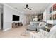 Comfortable living room featuring a gray sofa, ceiling fan, and view into the kitchen at 8410 Red Spruce Ave, Riverview, FL 33578