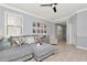 Open-concept living room features a comfortable gray sectional and plenty of natural light at 8410 Red Spruce Ave, Riverview, FL 33578