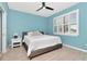 Bedroom features a ceiling fan, plantation shutters, and light blue painted walls at 8410 Red Spruce Ave, Riverview, FL 33578