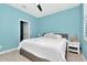 Bedroom features a ceiling fan, plantation shutters, and light blue painted walls at 8410 Red Spruce Ave, Riverview, FL 33578