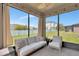 Relaxing screened patio featuring comfortable seating and an open view of the fenced backyard at 8410 Red Spruce Ave, Riverview, FL 33578
