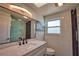 Elegant bathroom features a modern vanity, a large mirror, and a glass-enclosed shower with dark tile accents at 1933 Oregon Trl, Englewood, FL 34224