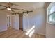 Bedroom boasts wood floors, a sliding closet door, and a sunlit window at 1933 Oregon Trl, Englewood, FL 34224