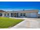Well-maintained single-story home with a manicured lawn and beautiful landscaping at 1933 Oregon Trl, Englewood, FL 34224