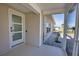 Inviting screened-in front porch with modern door and decorative accents at 1933 Oregon Trl, Englewood, FL 34224