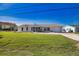 Charming single-story home with a well-maintained lawn and attached garage and screen front door at 1933 Oregon Trl, Englewood, FL 34224
