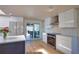 Stylish kitchen with modern appliances, sleek cabinetry, and a view to the outdoor dining area at 1933 Oregon Trl, Englewood, FL 34224