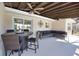 Covered outdoor patio with ceiling fans, comfortable seating, and a dining area at 1933 Oregon Trl, Englewood, FL 34224