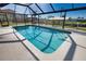 Inviting screened-in pool with clear blue water and a scenic view of the surrounding waterway at 1933 Oregon Trl, Englewood, FL 34224