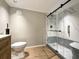 Modern bathroom featuring a glass shower with marble accents and wood look flooring at 5141 Oakland Hills Ave, Sarasota, FL 34234