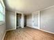 Bedroom features wood floors, closet with shelves, and glass paneled door to the exterior at 5141 Oakland Hills Ave, Sarasota, FL 34234