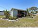 Charming home exterior with well-manicured landscaping and a beautifully designed garden bed at 5141 Oakland Hills Ave, Sarasota, FL 34234