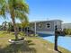Charming single-story home featuring a well-manicured lawn, tasteful landscaping, and a freshly painted exterior at 5141 Oakland Hills Ave, Sarasota, FL 34234