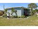 Charming home exterior with well-manicured landscaping and a beautifully designed garden bed at 5141 Oakland Hills Ave, Sarasota, FL 34234